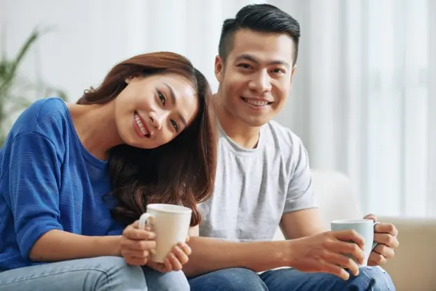 A couple smiling at the camera