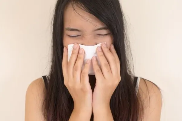 woman sneezing